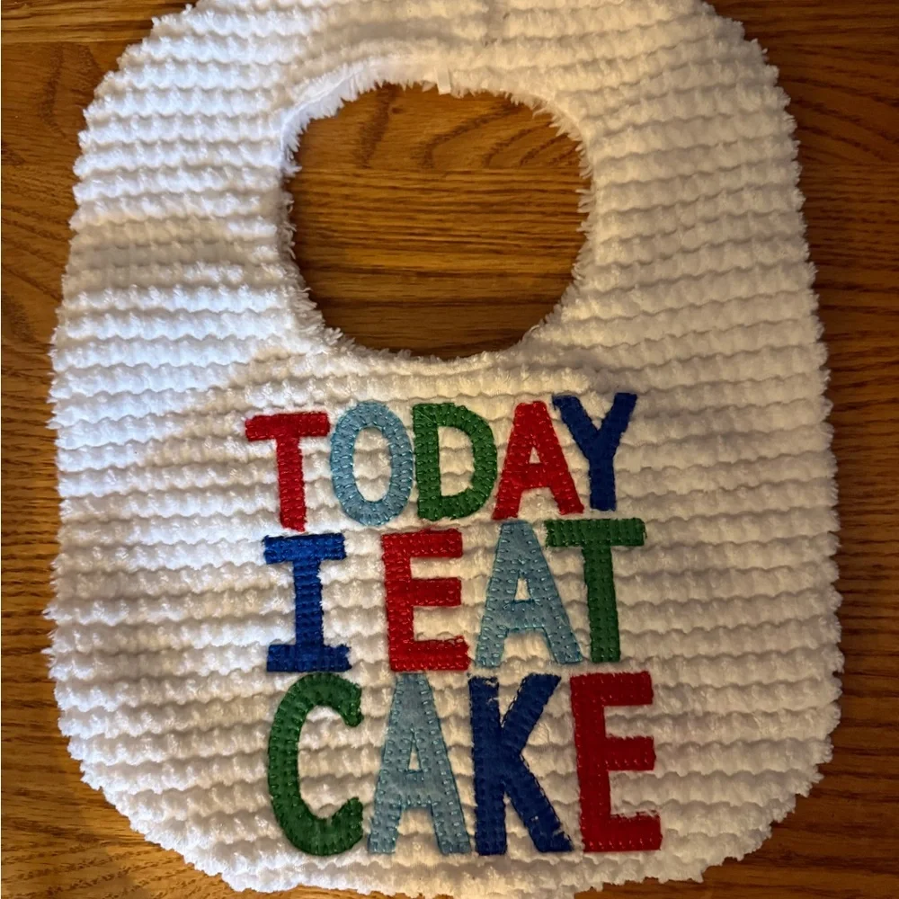 Mud Pie Plush White Baby Bib with Logo Patch